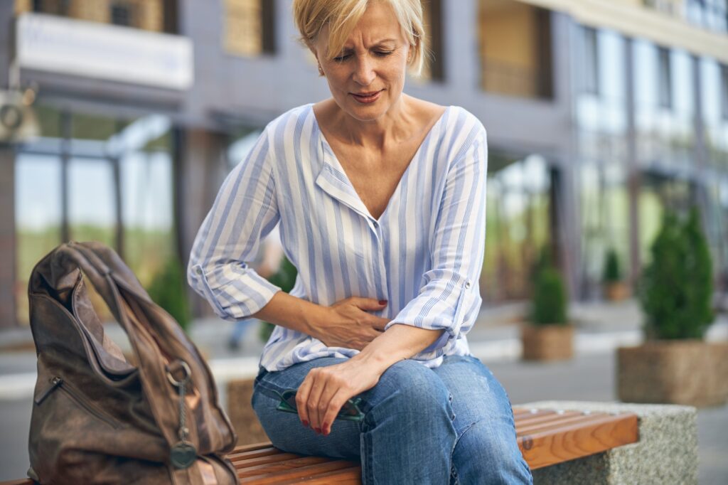 Mature Caucasian lady experiencing a severe stomachache